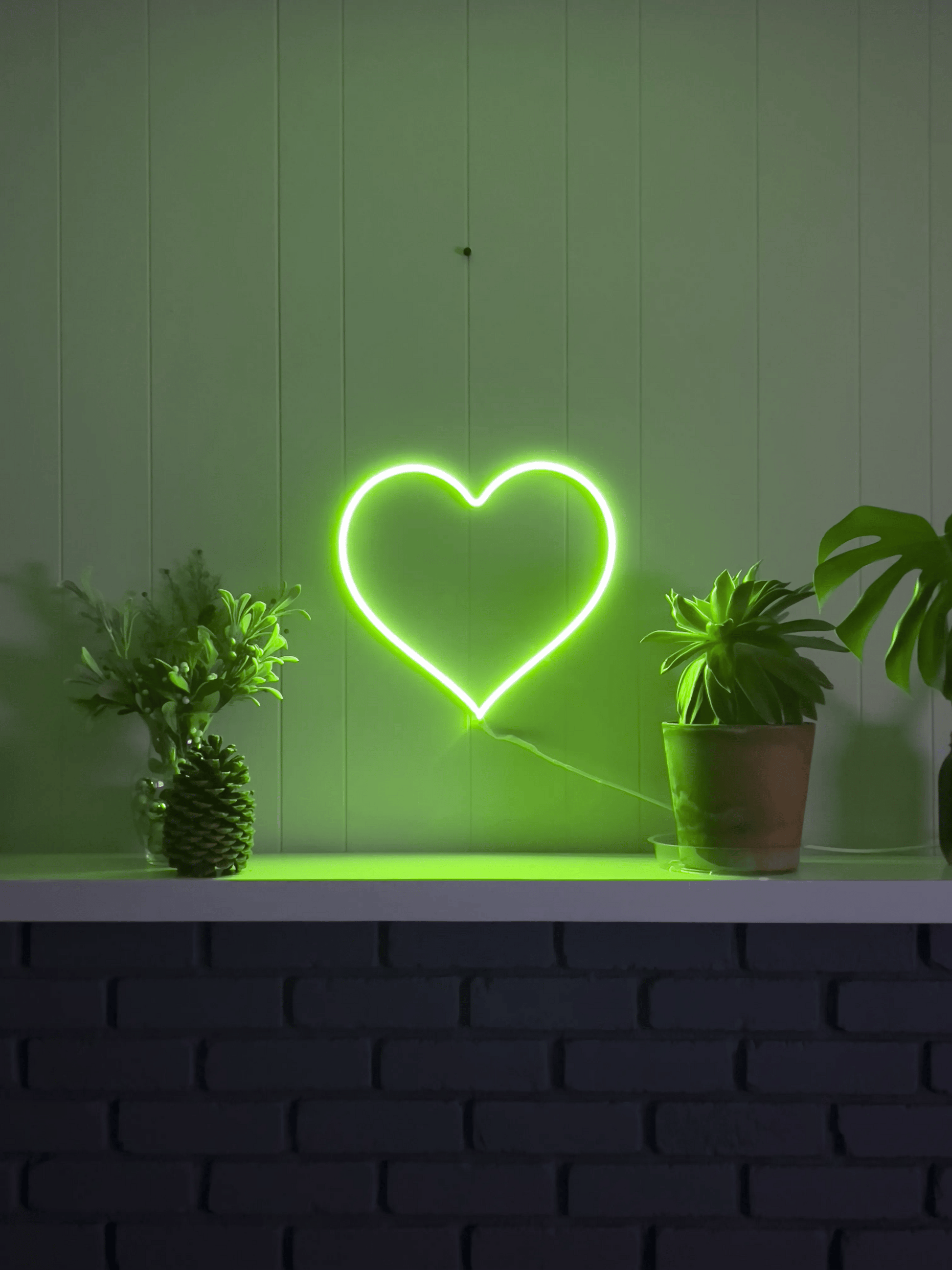 LED neon heart sign that's animated showing three solid colors it can display